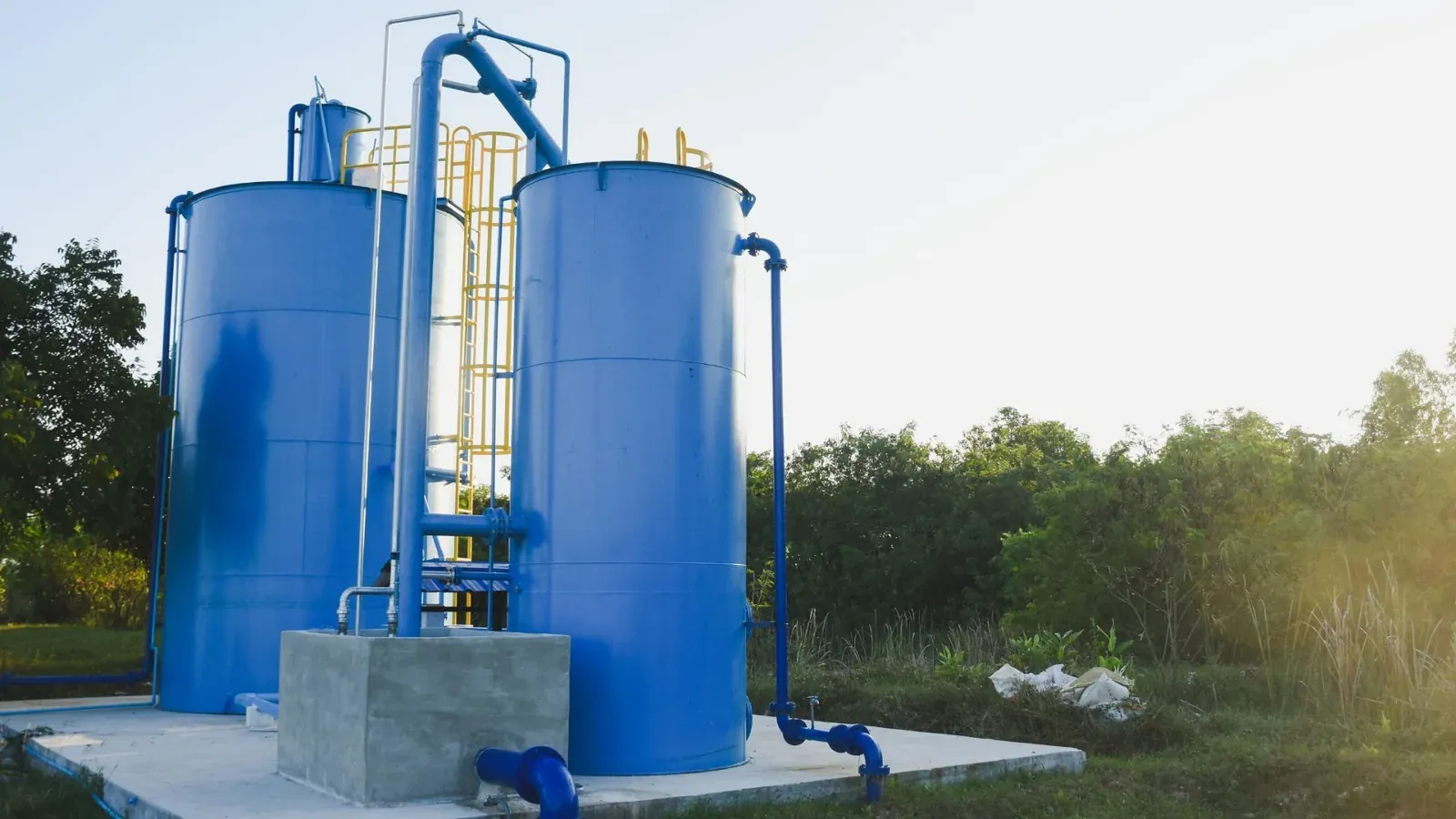 Blue modular steel water tanks installed at a facility, providing reliable bulk water storage for healthcare operations.