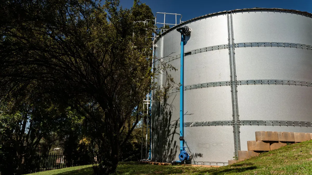 iWater modular galvanised steel water tank with blue pipework at a Gauteng logistics site