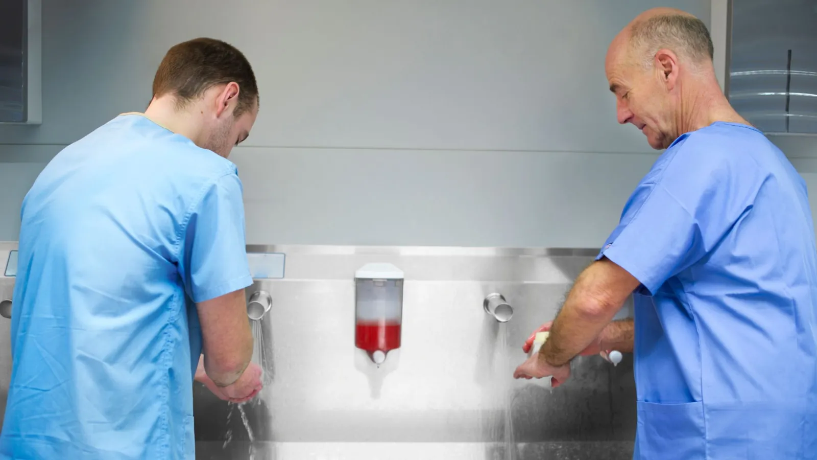 Healthcare professionals scrubbing at a clinical sink, showing hospital water dependency